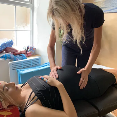 Maryellen carrying out pregnancy treatment on customer