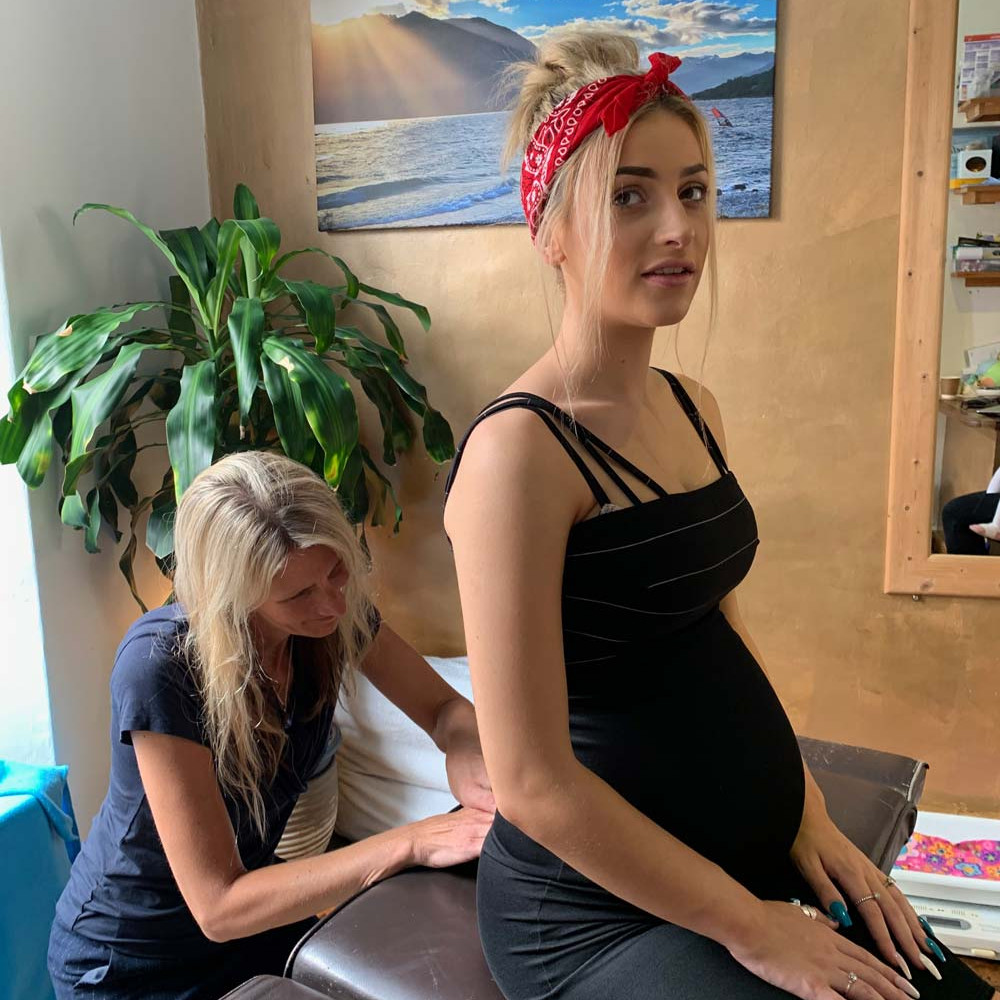 Maryellen carrying out pregnancy treatment on customer